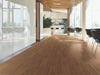Bosk Vinyl Commercial by Shaw Floors in the color Golden Hickory flooring in a home, showing the finished look.